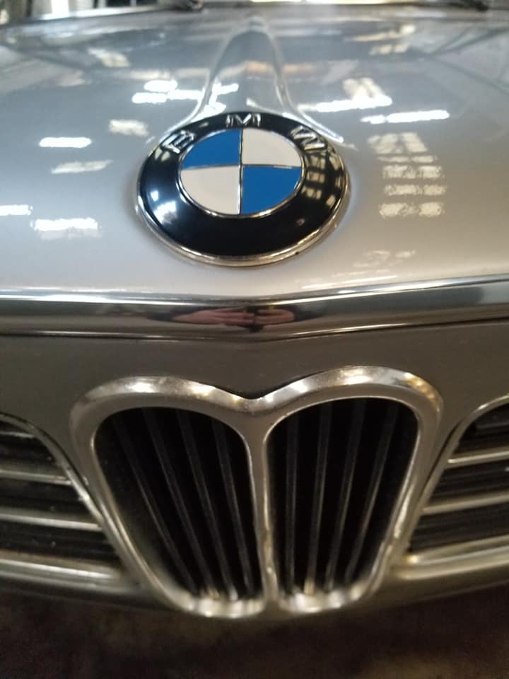 Logo BMW classique sur capot argenté au-dessus de la calandre emblématique en forme de double haricot chromé.